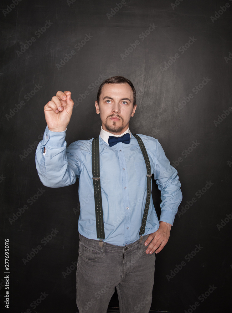 Handsome business man touch something on blackboard Handsome business man touch something on blackboard