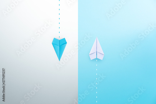 Blue and white paper planes flying in different directions. dissenting opinion, divergent views concepts