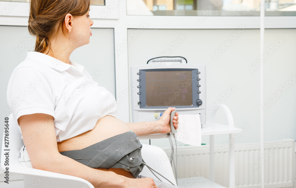 Pregnant woman performing cardiotocography CTG monitoring fetal ...