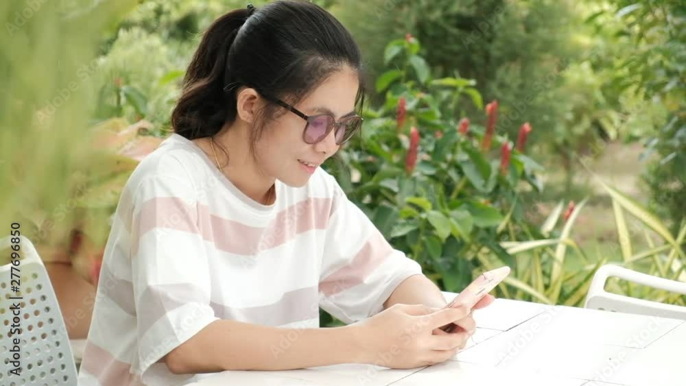 Slow motion. Business asian women using smartphone for reading and texting while sitting on table. Slow motion. Business asian women using smartphone for reading and texting while sitting on table.