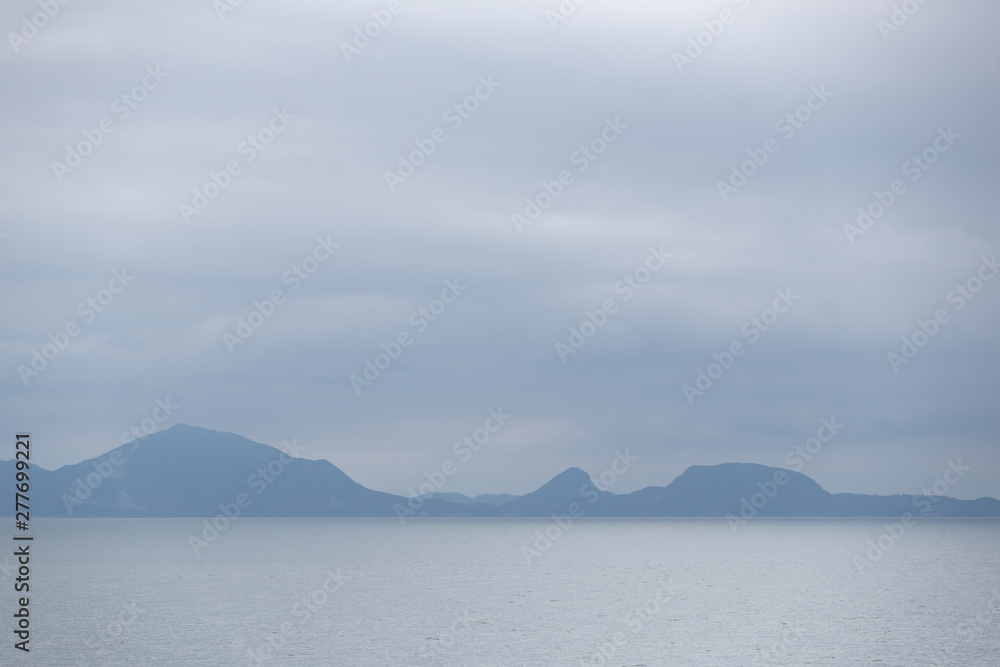 landscape view of blue mountain with sea and sky background.