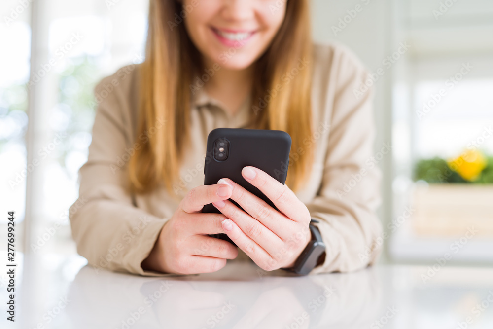 Close up of woman using smartphone and smiling confident Close up of woman using smartphone and smiling confident