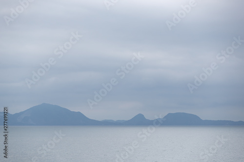 landscape view of blue mountain with sea and sky background.