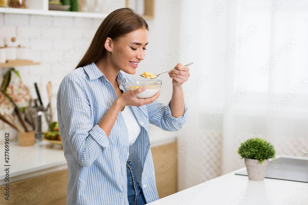 Healthy breakfast. Woman eating corn flakes with yogurt Healthy breakfast. Woman eating corn flakes with yogurt