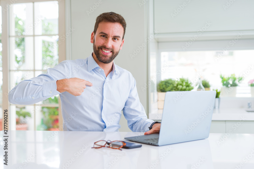 Handsome business man working using computer laptop with surprise face pointing finger to himself