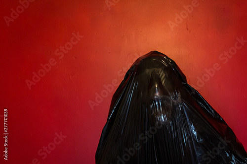 Slika na platnu Concept Image of Human Form Grinning Darkly from Inside Black Plastic Bag