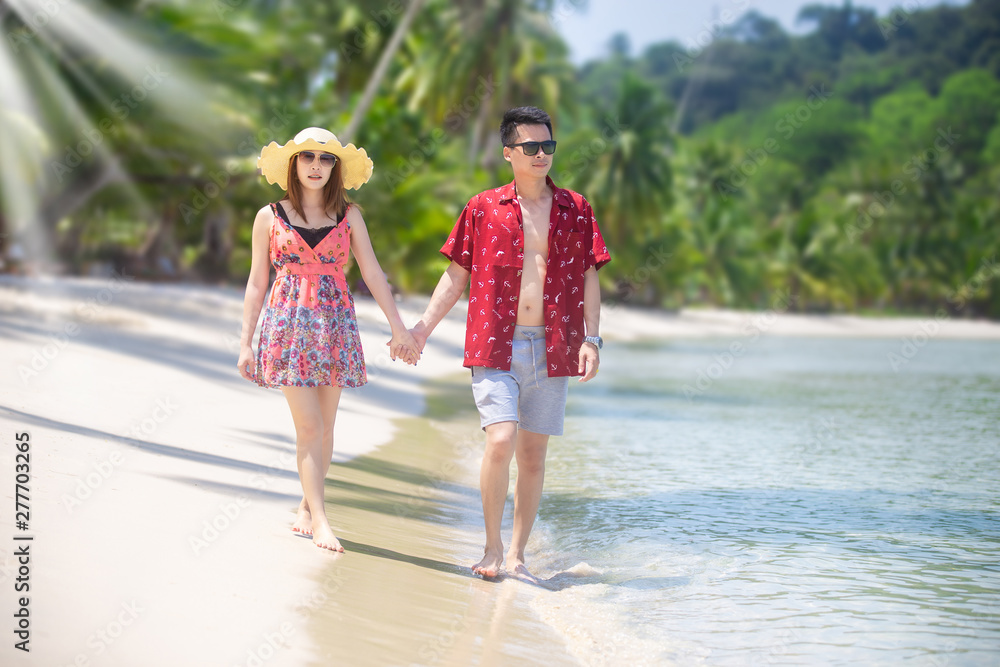 Lover couple honeymoon, walking on the beach at tropical sea. Lover couple honeymoon, walking on the beach at tropical sea.