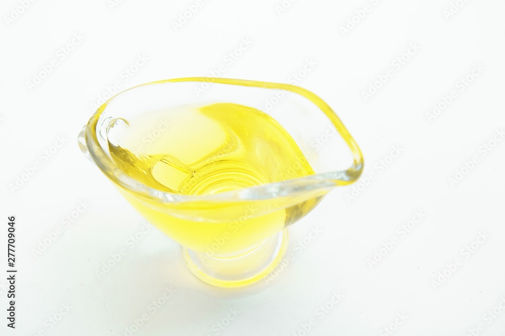 Top view of glass with olive oil on white background Top view of glass with olive oil on white background