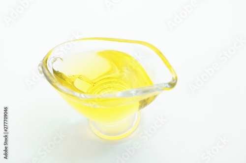 Top view of glass with olive oil on white background