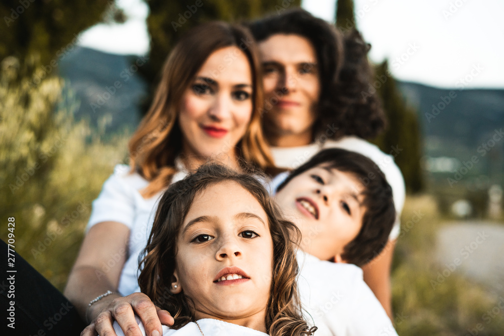 Portrait of a happy and funny young family outdoors Portrait of a happy and funny young family outdoors