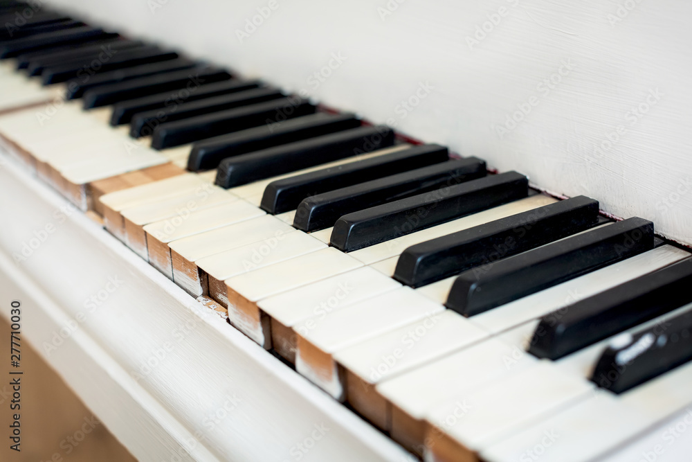 Keys of an old white piano with peeling paint close up Keys of an old white piano with peeling paint close up
