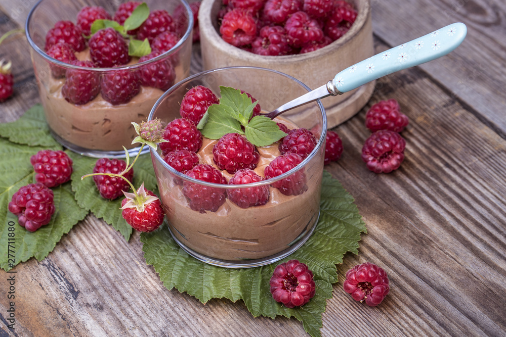 fresh raspberry with chocolate mousse in glass glasses on wooden background fresh raspberry with chocolate mousse in glass glasses on wooden background