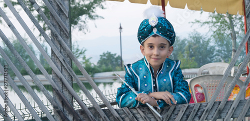 circumcision boy dressed in traditional clothing photo