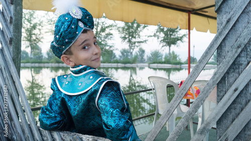 circumcision boy dressed in traditional clothing photo