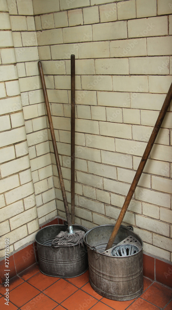Some Old Fashioned Floor Mops with Metal Buckets. Some Old Fashioned Floor Mops with Metal Buckets.