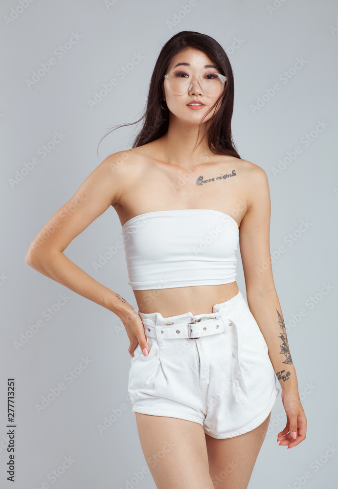 Beautiful young woman wearing white top and shorts Beautiful young woman wearing white top and shorts