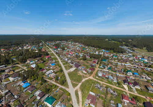 Sysert city. Russia. Aerial. City with low private houses and long streets. Sunny, summer photo