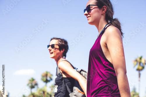Lifestyle photography. Two happy and urban lesbian girlfriends in a sunny day in summer
