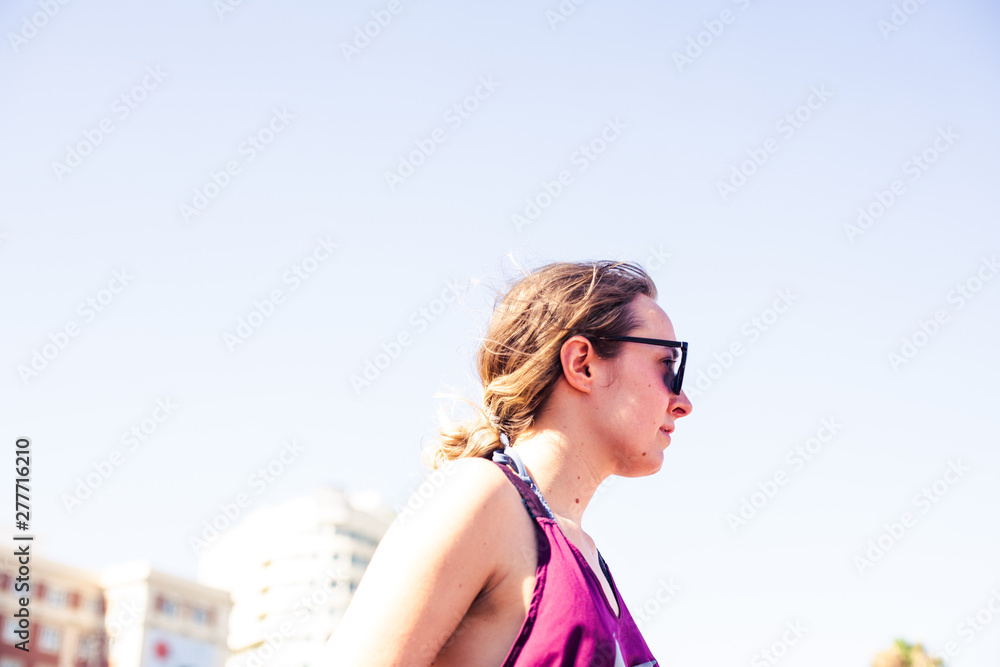 Lifestyle photography.  urban happy young woman in a sunny day