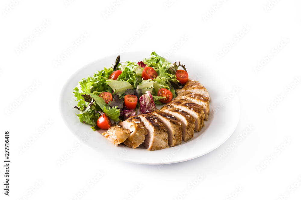 Grilled chicken breast with vegetables on a plate isolated on white background Grilled chicken breast with vegetables on a plate isolated on white background