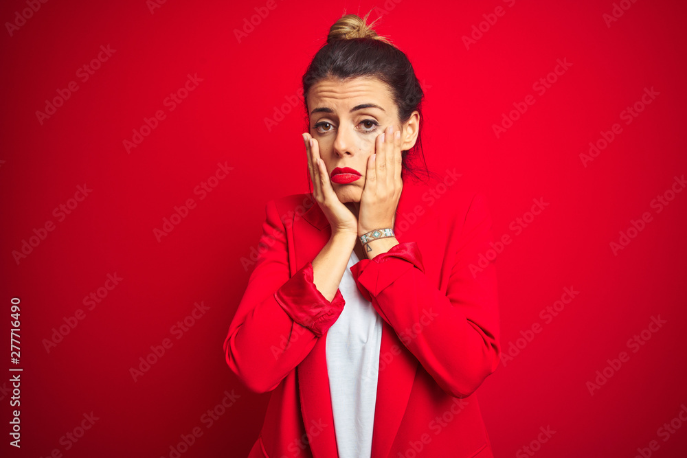 Young beautiful business woman standing over red isolated background Tired hands covering face, depression and sadness, upset and irritated for problem Young beautiful business woman standing over red isolated background Tired hands covering face, depression and sadness, upset and irritated for problem
