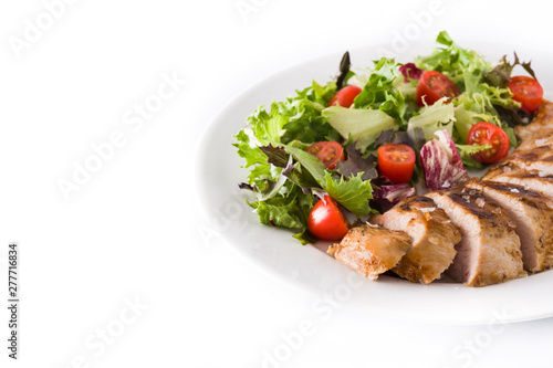 Grilled chicken breast with vegetables on a plate isolated on white background. Copyspace
