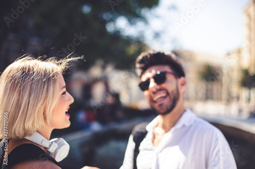 Lifestyle Photography. A blonde young girl and a young man relaxed in a sunny day in summer.