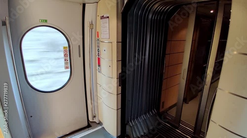 Doors closing in the interior of AVE train or Alta Velocidad Espanola, which is a high-speed rail service operated by the Spanish national railway company.