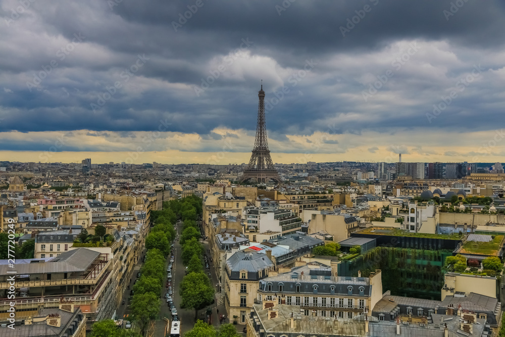 Panoramic aerial view of Paris with the famous and iconic Eiffel Tower in the centre and the Avenue d'Iéna leading to the Trocadéro on a cloudy day.