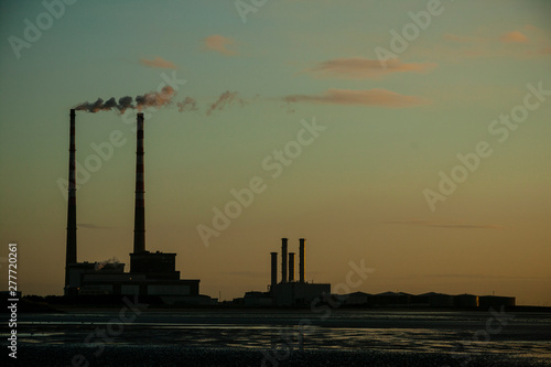 Poolbeg Gas/Oil Power Station seen from Sandymount strand, Dublin, Ireland. Early morning
