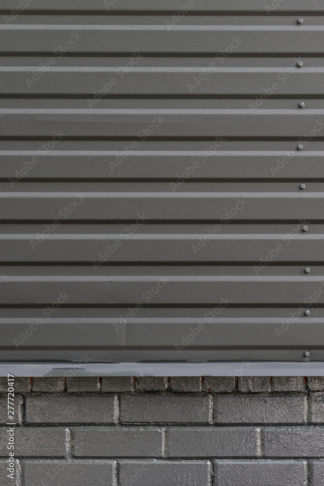 Gray city wall. Dark gray urban background. Copy space for text.Abstract background corrugated gray metal for wall pattern, industrial. Gray city wall. Dark gray urban background. Copy space for text.Abstract background corrugated gray metal for wall pattern, industrial.
