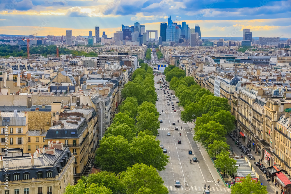 Great panoramic aerial view of the skyline of the business district La Défense in Paris with the Grande Arche seen from the Arc de Triomphe on the Axe historique on a nice sunny day with blue sky. 