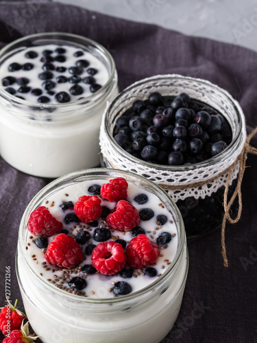 Milk yogurt with blueberries, raspberries, detox. Copy space.