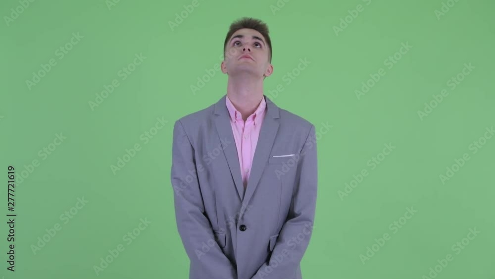 Stressed young businessman looking bored and tired Stressed young businessman looking bored and tired