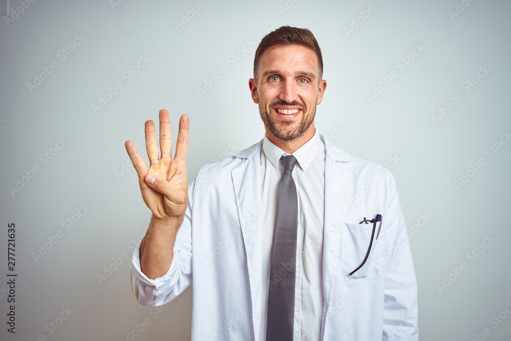 Young handsome doctor man wearing white profressional coat over isolated background showing and pointing up with fingers number four while smiling confident and happy. Young handsome doctor man wearing white profressional coat over isolated background showing and pointing up with fingers number four while smiling confident and happy.