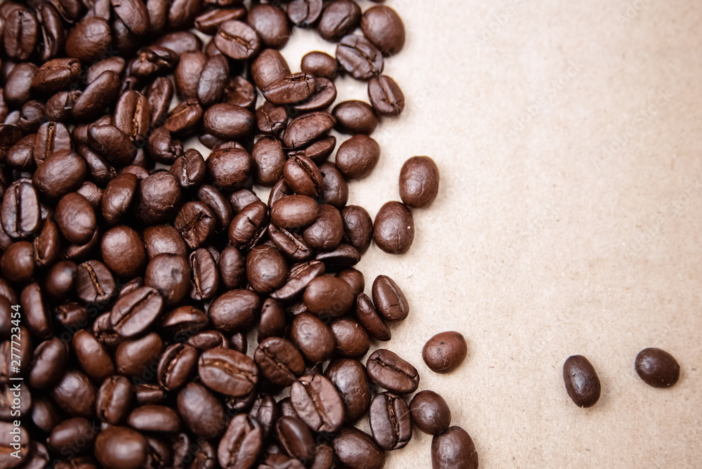 Coffee beans put at the left side of brown background,burry light around Coffee beans put at the left side of brown background,burry light around