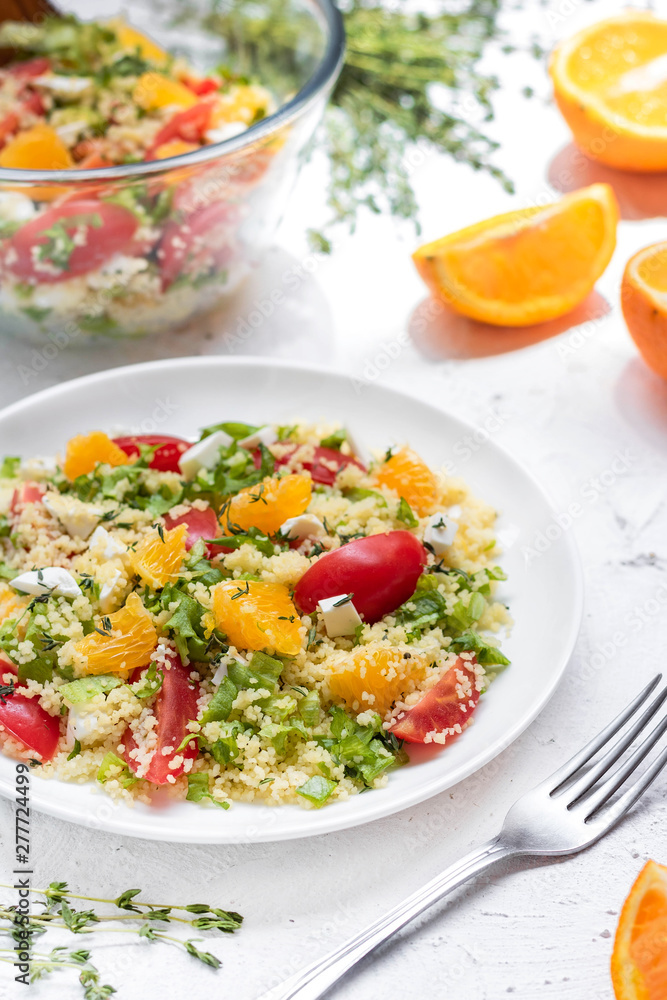 Healthy and simple food, light summer lunch, fragrant salad with couscous and oranges Healthy and simple food, light summer lunch, fragrant salad with couscous and oranges