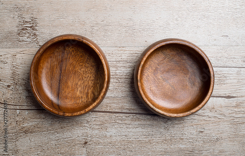 From above two brown wooden bowls on gray wooden table. Traditional rustic bowl.
