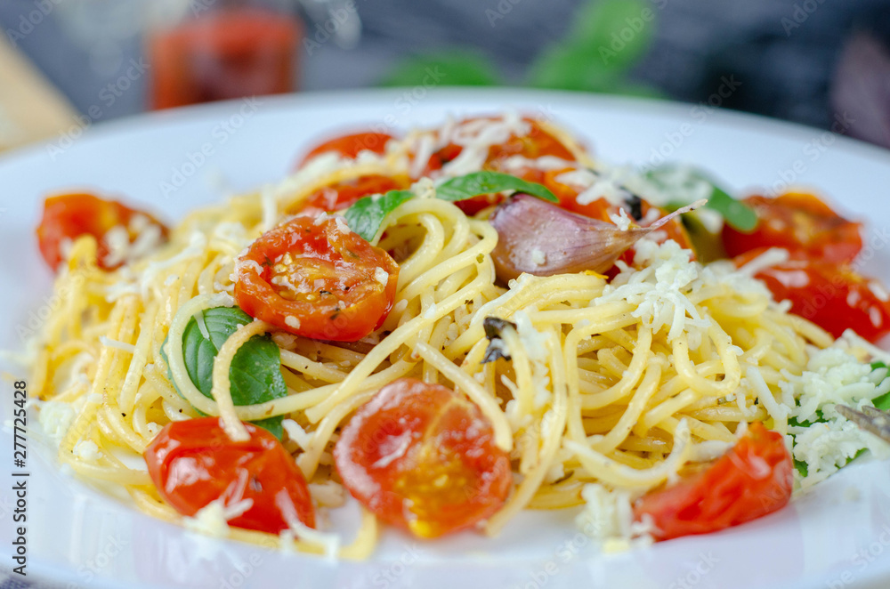 Fresh pasta with garlic Cherry Tomatoes and basil. Delicious Pasta Plate. Spaghetti. Italian food. Italy. Roma. Fine dining. Healthy food. Vegetarian. Healthy food Fresh pasta with garlic Cherry Tomatoes and basil. Delicious Pasta Plate. Spaghetti. Italian food. Italy. Roma. Fine dining. Healthy food. Vegetarian. Healthy food