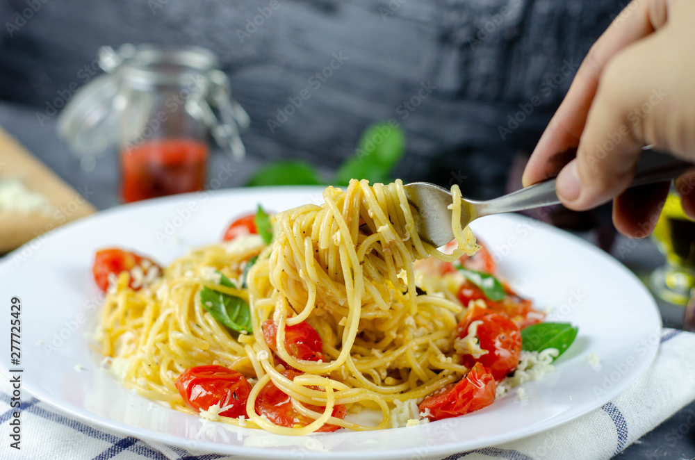 Fresh pasta with garlic Cherry Tomatoes and basil. Delicious Pasta Plate. Spaghetti. Italian food. Italy. Roma. Fine dining. Healthy food. Vegetarian. Healthy food Fresh pasta with garlic Cherry Tomatoes and basil. Delicious Pasta Plate. Spaghetti. Italian food. Italy. Roma. Fine dining. Healthy food. Vegetarian. Healthy food