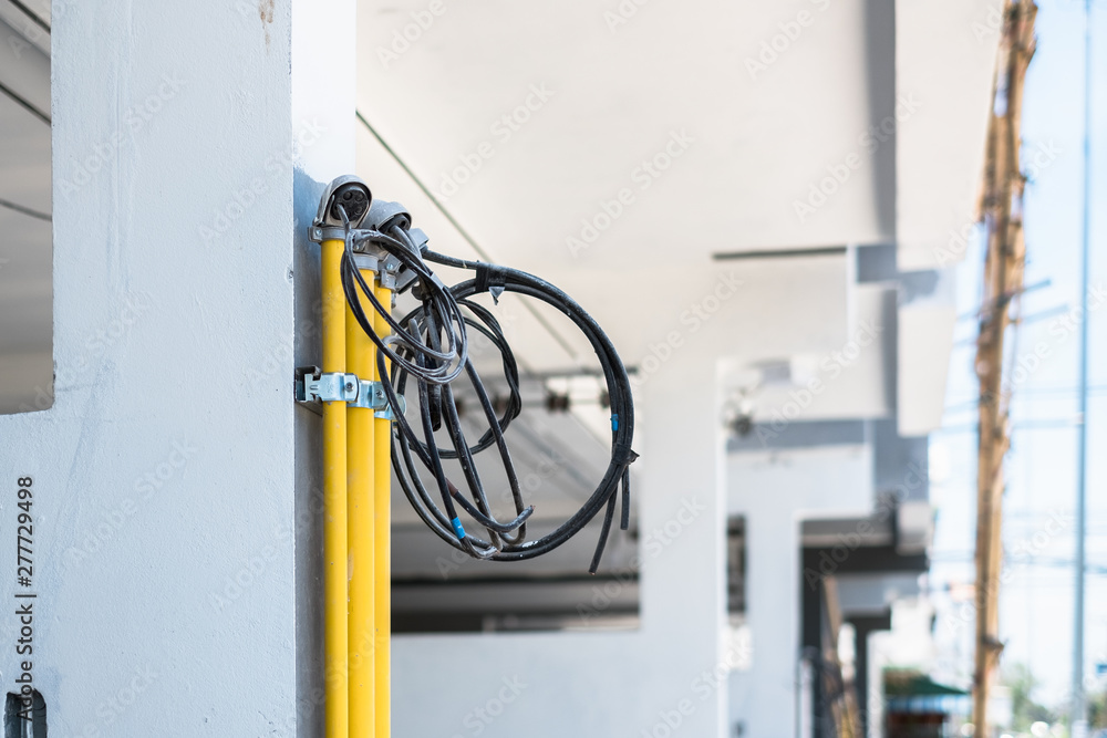 New electrical wires installation in yellow pvc pipes outdoor for new building house. New electrical wires installation in yellow pvc pipes outdoor for new building house.