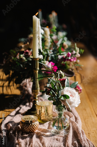 an elegant table setting with flowers and candles