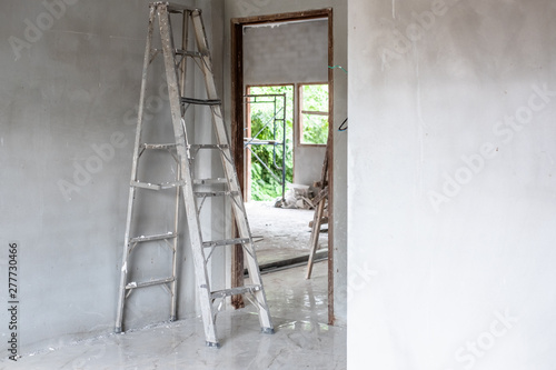 Home improvement concept with steel ladder and white wall in empty room