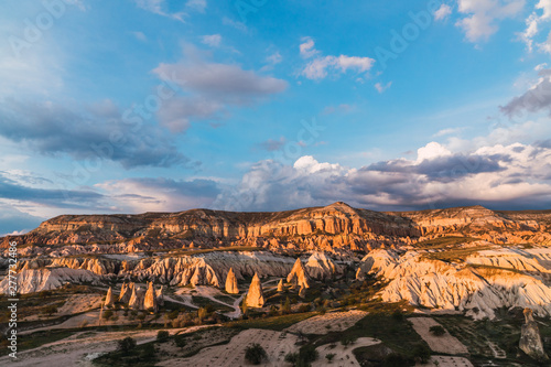 Rough stone formations located in wonderful valley on sunny day in Cappadocia, Turkey photo