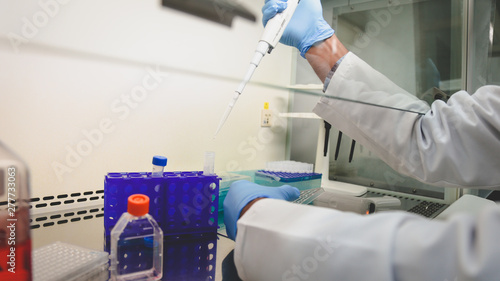 scientist in laboratory with test tubes