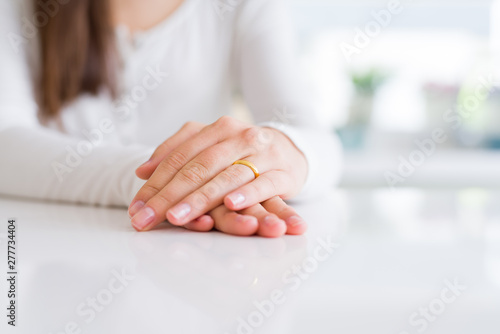 Close up of woman hands wearing wedding alliance ring