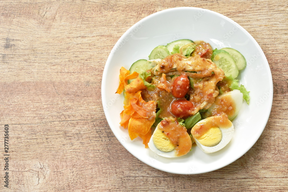 Islamic salad vegetable and boiled egg topping crispy fried taro dressing sweet bean sauce halal food on plate Islamic salad vegetable and boiled egg topping crispy fried taro dressing sweet bean sauce halal food on plate