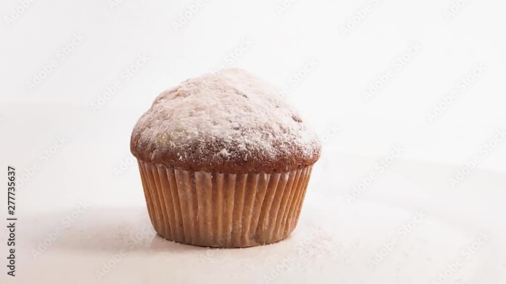 flavored cupcake, sprinkle with powdered sugar at the restaurant in slow motion flavored cupcake, sprinkle with powdered sugar at the restaurant in slow motion