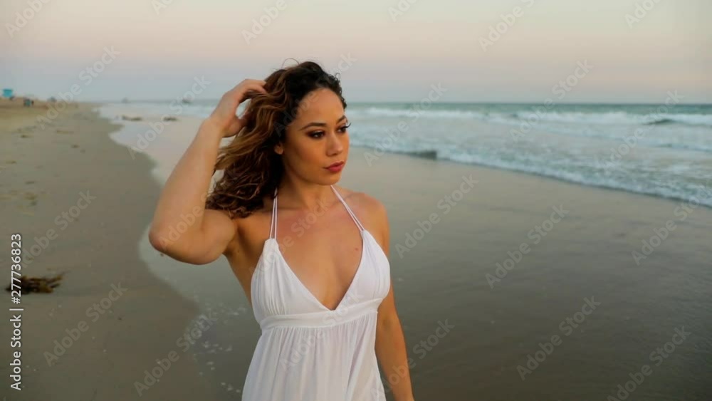 Beautiful woman enjoying the beach at sunset. Beautiful woman enjoying the beach at sunset.