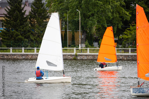 single small sailing boats on the lake